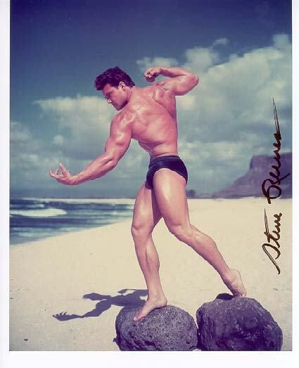 Steve Reeves poses atop two rocks at the beach.