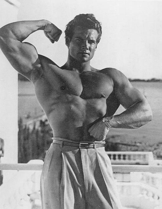 Actor and bodybuilder Steve Reeves hits an arm shot.